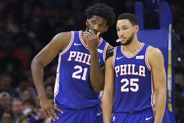 Philadelphia 76ers' Joel Embiid, left, talks things over with Ben Simmons, right, during the second half of an NBA basketball game against the New York Knicks, Wednesday, Nov. 20, 2019, in Philadelphia. The 76ers won 109-104. (AP Photo/Chris Szagola)