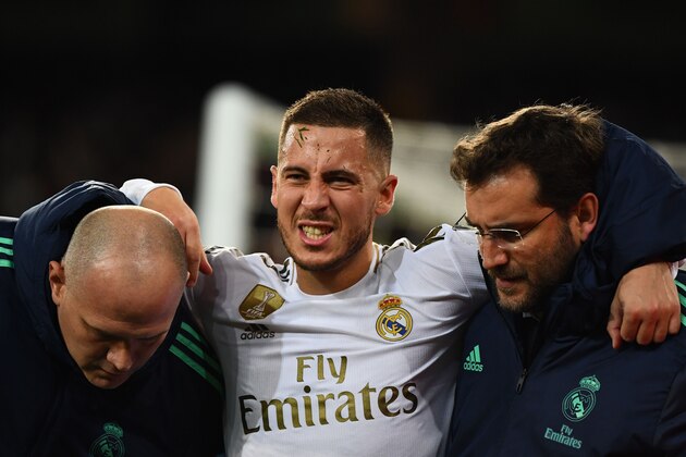 Real Madrid's Belgian forward Eden Hazard gestures in pain during the UEFA Champions League group A football match Real Madrid against Paris Saint-Germain FC at the Santiago Bernabeu stadium in Madrid on November 26, 2019. (Photo by GABRIEL BOUYS / AFP) (Photo by GABRIEL BOUYS/AFP via Getty Images)