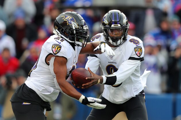 ORCHARD PARK, NY - DECEMBER 08:  Lamar Jackson #8 of the Baltimore Ravens hands the ball off to Mark Ingram #21 during a game against the Buffalo Bills at New Era Field on December 8, 2019 in Orchard Park, New York.  Baltimore beats Buffalo 24 to 17. (Photo by Timothy T Ludwig/Getty Images)