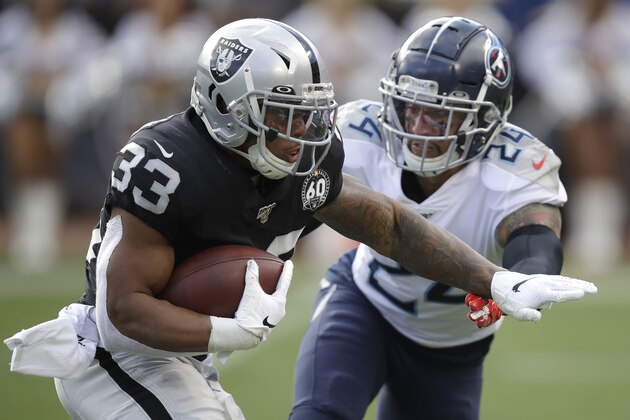 Oakland Raiders running back DeAndre Washington (33) runs for a touchdown past Tennessee Titans strong safety Kenny Vaccaro (24) during the first half of an NFL football game in Oakland, Calif., Sunday, Dec. 8, 2019. (AP Photo/Ben Margot)