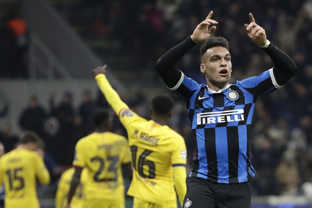 Inter Milan's Lautaro Martinez, right, reacts after a missed scoring opportunity during the Champions League, group F soccer match between Inter Milan and F.C. Barcelona, at the San Siro stadium in Milan, Italy, Tuesday, Dec. 10, 2019. (AP Photo/Luca Bruno)