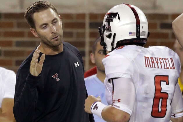 Texas Tech head coach Kliff Kingsbury, left, congratulates quarterback Baker Mayfield (6) after he scored a touchdown during the second half of an NCAA college football game against Southern Methodist Friday, Aug. 30, 2013, in Dallas. Texas Tech won 41-23. (AP Photo/LM Otero)