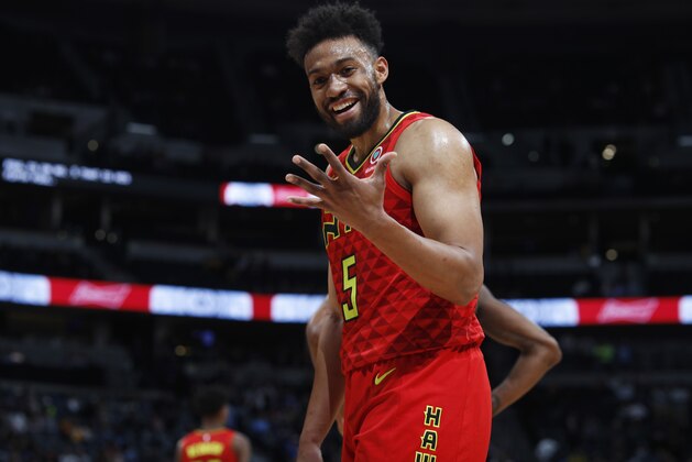 Atlanta Hawks forward Jabari Parker laughs as he tells a fan that he has four fouls, not five, late in the second half of the team's NBA basketball game against the Denver Nuggets on Tuesday, Nov. 12, 2019, in Denver. Atlanta won 125-121. (AP Photo/David Zalubowski)
