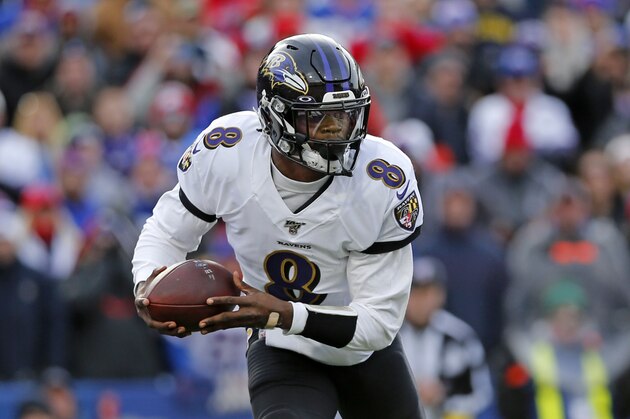 Baltimore Ravens quarterback Lamar Jackson (8) carries the football during the first half of an NFL football game against the Buffalo Bills in Orchard Park, N.Y., Sunday, Dec. 8, 2019. (AP Photo/John Munson)