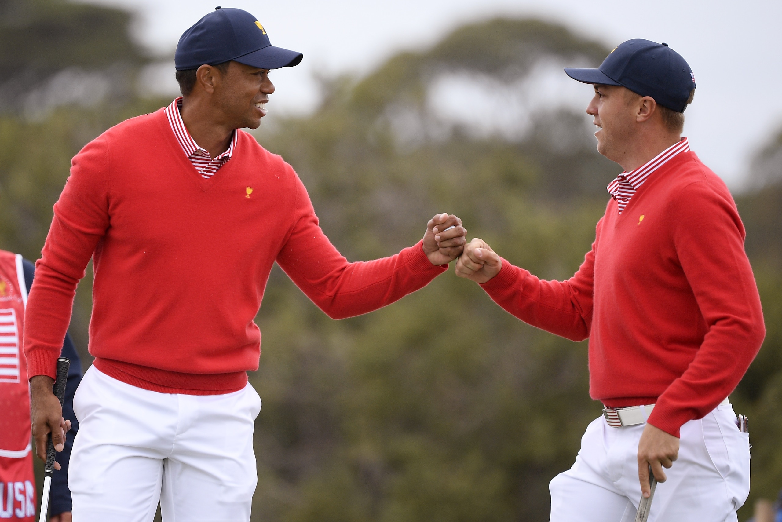 U.S. team player and captain Tiger Woods, left, and teammate Justin Thomas celebrate after Woods birdied the 5th during their fourball match at the Royal Melbourne Golf Club in the opening rounds of the President's Cup golf tournament in Melbourne, Thursday, Dec. 12, 2019. (AP Photo/Andy Brownbill)
