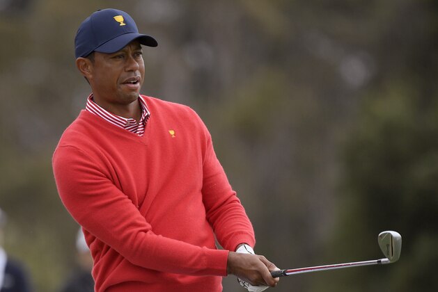 U.S. team player and captain Tiger Woods watches his approach shot on the 6th hole during their fourball match at the Royal Melbourne Golf Club in the opening rounds of the President's Cup golf tournament in Melbourne, Thursday, Dec. 12, 2019. (AP Photo/Andy Brownbill)