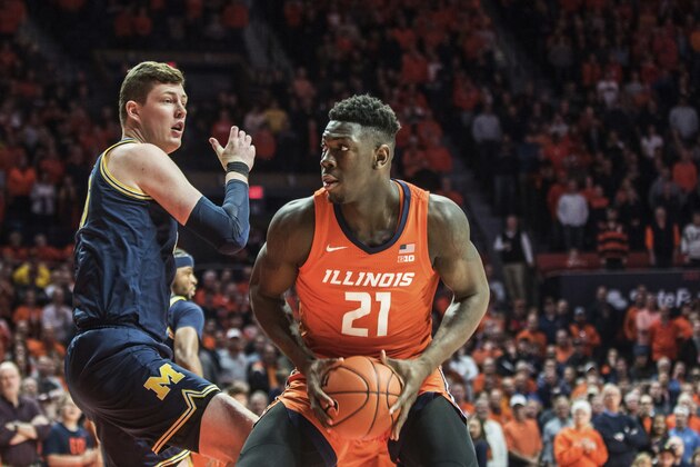 Illinois' Kofi Cockburn (21) looks to shoot as Michigan's Jon Teske (15) defends in the first half of an NCAA college basketball game, Wednesday, Dec. 11, 2019, in Champaign, Ill. (AP Photo/Holly Hart)