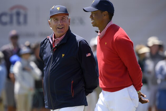 U.S. team player and captain Tiger Woods, right, and Fred Couples walk along the 16th fairway at the Royal Melbourne Golf Club in the opening rounds of the President's Cup golf tournament in Melbourne, Thursday, Dec. 12, 2019. (AP Photo/Andy Brownbill)