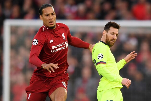 LIVERPOOL, ENGLAND - MAY 07:  Virgil van Dijk of Liverpool and Lionel Messi of Barcelona watch the ball during the UEFA Champions League Semi Final second leg match between Liverpool and Barcelona at Anfield on May 07, 2019 in Liverpool, England. (Photo by Shaun Botterill/Getty Images)