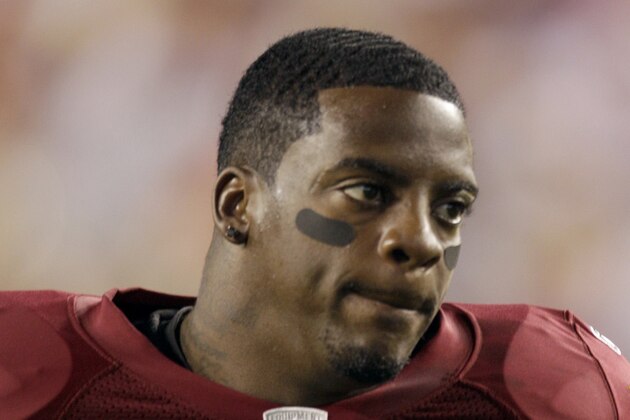 FILE - This Sept. 12, 2010, file photo shows Washington Redskins running back Clinton Portis before the start of an NFL football game against the Dallas Cowboys, in Landover, Md. Ten former NFL players have been charged with defrauding the leagueâ€™s healthcare benefit program. They include five who played on the Washington Redskins, including Clinton Portis and Carlos Rogers.  (AP Photo/Rob Carr, File)