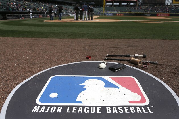 The Major League Baseball logo serves as the visitor's on deck circle before a baseball game between the Chicago White Sox and the Cleveland Indians Wednesday, April 24, 2013, in Chicago. (AP Photo/Charles Rex Arbogast)