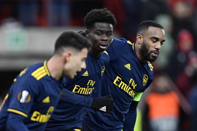 Arsenal's English striker Bukayo Saka (C) celebrates with teammate Arsenal's French striker Alexandre Lacazette (R) after scoring a goal during the UEFA Europa League Group F football match between R. Standard de Liege and Arsenal FC at the Maurice Dufrasne Stadium in Sclessin on December 12, 2019. (Photo by JOHN THYS / AFP) (Photo by JOHN THYS/AFP via Getty Images)