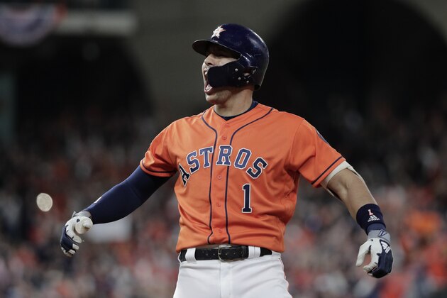 Houston Astros' Carlos Correa reacts to his RBI single during the fifth inning of Game 7 of the baseball World Series against the Washington Nationals Wednesday, Oct. 30, 2019, in Houston. (AP Photo/David J. Phillip)