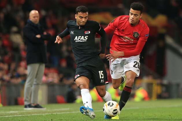 AZ Alkmaar's Dutch defender Owen Wijndal (L) takes on Manchester United's striker Mason Greenwood (R) during the UEFA Europa League group L football match between Manchester United and AZ Almaar at Old Trafford in Manchester, north west England, on December 12, 2019. (Photo by Lindsey Parnaby / AFP) (Photo by LINDSEY PARNABY/AFP via Getty Images) AZ Alkmaar's Dutch defender Owen Wijndal (L) takes on Manchester United's striker Mason Greenwood (R) during the UEFA Europa League group L football match between Manchester United and AZ Almaar at Old Trafford in Manchester, north west England, on December 12, 2019. (Photo by Lindsey Parnaby / AFP) (Photo by LINDSEY PARNABY/AFP via Getty Images)