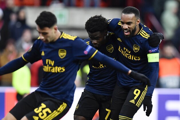 Arsenal's English striker Bukayo Saka (C) celebrates with Arsenal's French striker Alexandre Lacazette (R) after scoring a goal during the UEFA Europa League Group F football match between R. Standard de Liege and Arsenal FC at the Maurice Dufrasne Stadium in Sclessin on December 12, 2019. (Photo by JOHN THYS / AFP) (Photo by JOHN THYS/AFP via Getty Images)