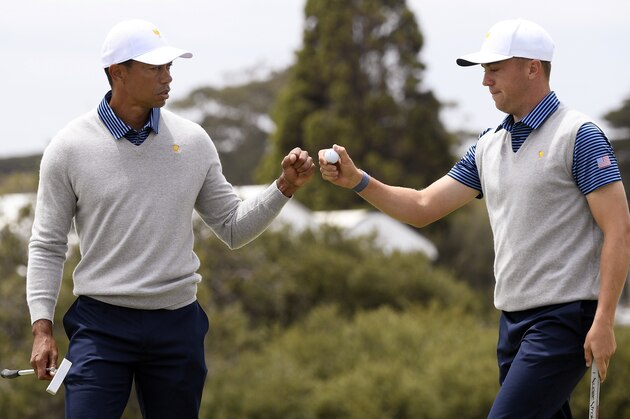 U.S. team player and captain Tiger Woods, left, and playing partner Justin Thomas fist bump after playing the 5th hole in their foursomes match during the President's Cup golf tournament at Royal Melbourne Golf Club in Melbourne, Friday, Dec. 13, 2019. (AP Photo/Andy Brownbill)