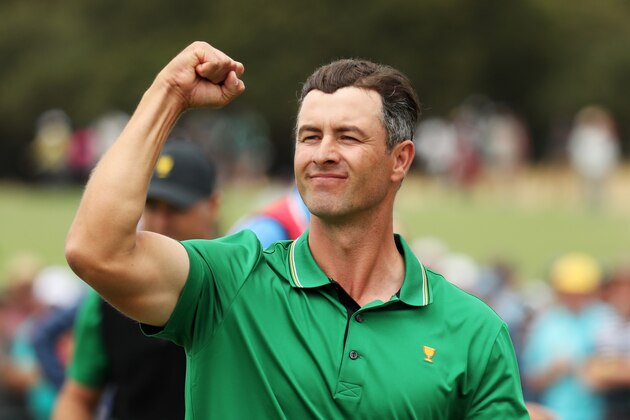 MELBOURNE, AUSTRALIA - DECEMBER 13: Adam Scott of Australia and the International team celebrates after he and Louis Oosthuizen of South Africa and the International team defeated Dustin Johnson of the United States team and Matt Kuchar of the United States team 3&2 during Friday foursome matches on day two of the 2019 Presidents Cup at Royal Melbourne Golf Course on December 13, 2019 in Melbourne, Australia. (Photo by Rob Carr/Getty Images)