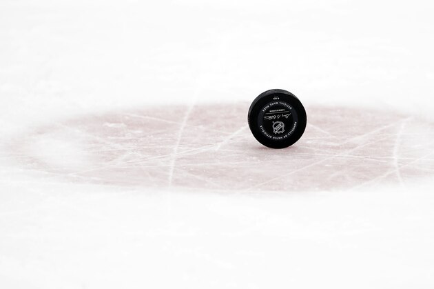 A puck sits on the ice before a face-off in the first period of an NHL hockey game between the Nashville Predators and the Minnesota Wild Saturday, Oct. 5, 2019, in Nashville, Tenn. (AP Photo/Mark Humphrey)