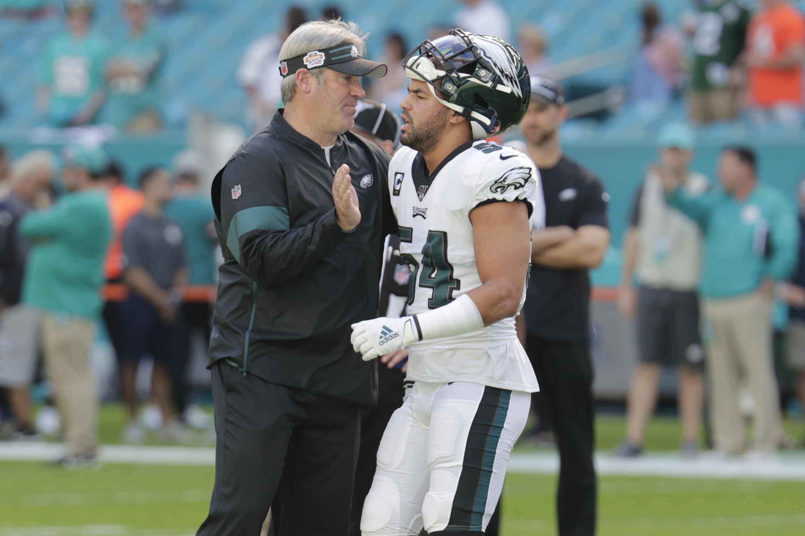 Philadelphia Eagles head coach Doug Pederson talks to outside linebacker Kamu Grugier-Hill (54), before an NFL football game against the Miami Dolphins, Sunday, Dec. 1, 2019, in Miami Gardens, Fla. (AP Photo/Lynne Sladky)