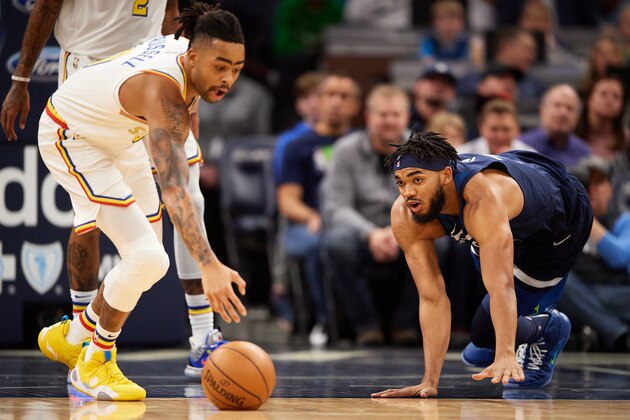 MINNEAPOLIS, MINNESOTA - NOVEMBER 08: Karl-Anthony Towns #32 of the Minnesota Timberwolves looks on as D'Angelo Russell #0 of the Golden State Warriors recovers a loose ball during the game at Target Center on November 8, 2019 in Minneapolis, Minnesota. NOTE TO USER: User expressly acknowledges and agrees that, by downloading and or using this Photograph, user is consenting to the terms and conditions of the Getty Images License Agreement (Photo by Hannah Foslien/Getty Images)