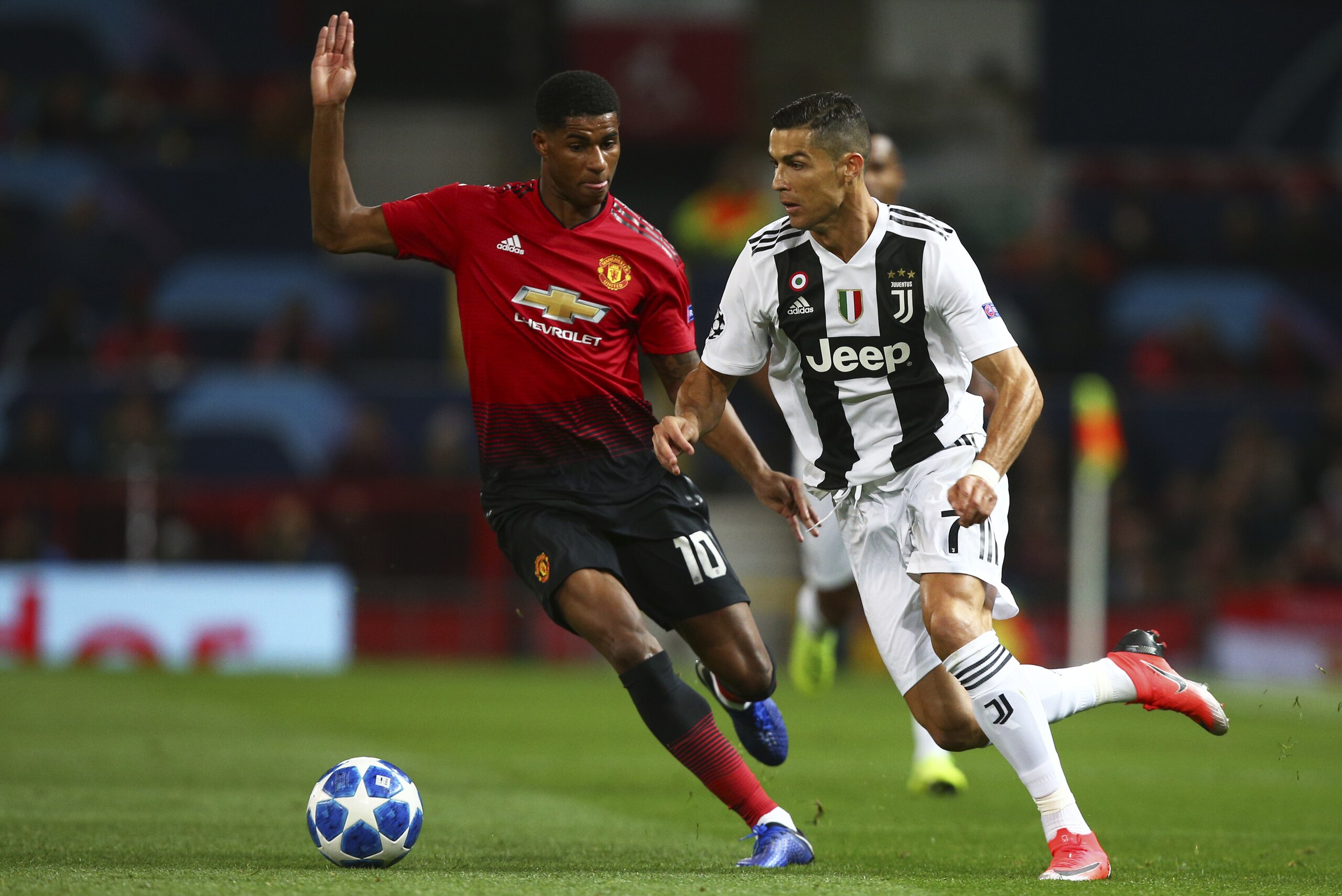 Juventus forward Cristiano Ronaldo drives the ball past ManU forward Marcus Rashford, left, during the Champions League group H soccer match between Manchester United and Juventus at Old Trafford, Manchester, England, Tuesday, Oct. 23, 2018. (AP Photo/Dave Thompson) Juventus forward Cristiano Ronaldo drives the ball past ManU forward Marcus Rashford, left, during the Champions League group H soccer match between Manchester United and Juventus at Old Trafford, Manchester, England, Tuesday, Oct. 23, 2018. (AP Photo/Dave Thompson)