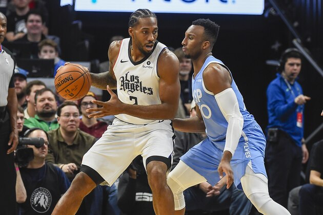 Los Angeles Clippers forward Kawhi Leonard, left, tries to get past Minnesota Timberwolves guard Josh Okogie during the first half of an NBA basketball game Friday, Dec. 13, 2019, in Minneapolis. (AP Photo/Craig Lassig)