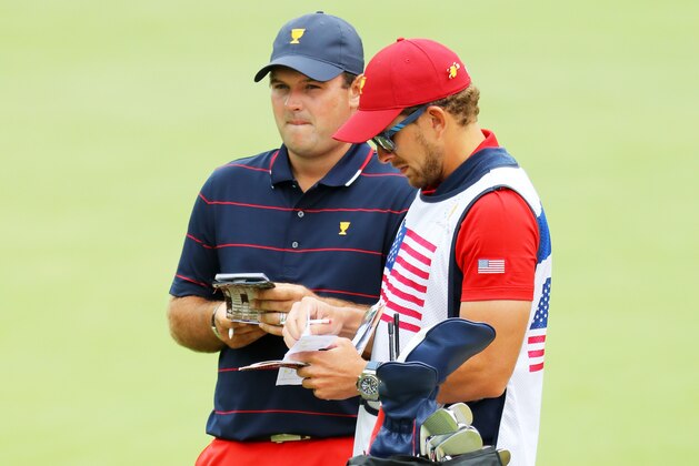 MELBOURNE, AUSTRALIA - DECEMBER 14: Patrick Reed of the United States team talks with his caddie Kessler Karain during Saturday four-ball matches on day three of the 2019 Presidents Cup at Royal Melbourne Golf Course on December 14, 2019 in Melbourne, Australia. (Photo by Warren Little/Getty Images)