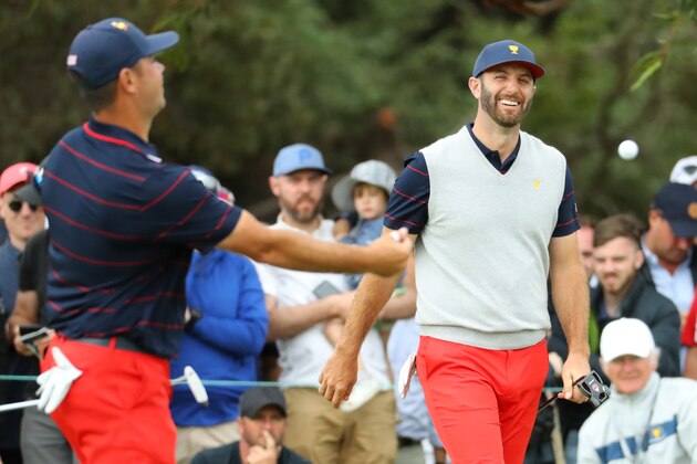 MELBOURNE, AUSTRALIA - DECEMBER 14: Dustin Johnson of the United States team and Gary Woodland of the United States team react on the 17th green after defeating Louis Oosthuizen of South Africa and the International team and Adam Scott of Australia and the International team 2&1 during Saturday afternoon foursomes matches on day three of the 2019 Presidents Cup at Royal Melbourne Golf Course on December 14, 2019 in Melbourne, Australia. (Photo by Warren Little/Getty Images)