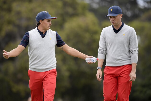 U.S. team player Rickie Fowler, left, and playing partner Justin Thomas talk while walking on the 6th fairway in their foursome match during the President's Cup golf tournament at Royal Melbourne Golf Club in Melbourne, Saturday, Dec. 14, 2019. (AP Photo/Andy Brownbill)