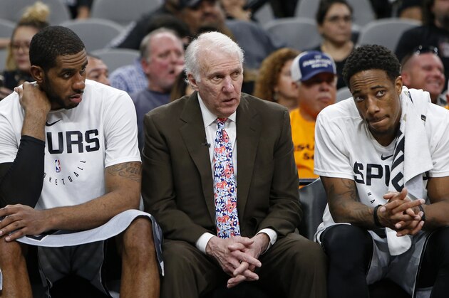 SAN ANTONIO, TX - NOVEMBER 30: Gregg Popovich head coach of the San Antonio Spurs talks with players LaMarcus Aldridge #12, and DeMar DeRozan #10 on the bench during an NBA game against the Houston Rockets held November 30, 2018 at the AT&T Center in San Antonio, Texas. The Houston Rockets won 136-105.  NOTE TO USER: User expressly acknowledges and agrees that, by downloading and or using this photograph, User is consenting to the terms and conditions of the Getty Images License Agreement.  (Photo by Edward A. Ornelas/Getty Images)
