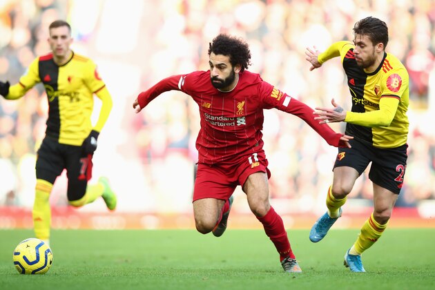 LIVERPOOL, ENGLAND - DECEMBER 14: Mohamed Salah of Liverpool holds off Kiko Femenia of Watford  during the Premier League match between Liverpool FC and Watford FC at Anfield on December 14, 2019 in Liverpool, United Kingdom. (Photo by Clive Brunskill/Getty Images)