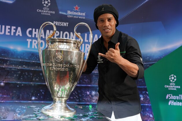 KUALA LUMPUR, MALAYSIA - APRIL 07: Former Brazil and Barcelona player Ronaldinho poses with the UEFA Champions League trophy during the UEFA Champions League trophy Tour of Malaysia at the Pavillion on April 7, 2018 in Kuala Lumpur, Malaysia. (Photo by Allsport Co./Getty Images) KUALA LUMPUR, MALAYSIA - APRIL 07: Former Brazil and Barcelona player Ronaldinho poses with the UEFA Champions League trophy during the UEFA Champions League trophy Tour of Malaysia at the Pavillion on April 7, 2018 in Kuala Lumpur, Malaysia. (Photo by Allsport Co./Getty Images)