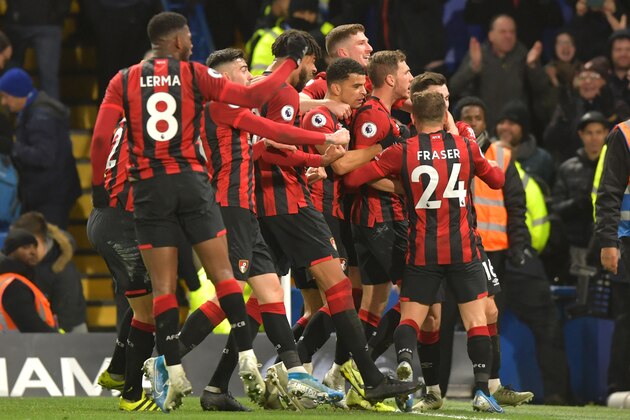Bournemouth's English midfielder Dan Gosling celebrates with teammates after he scores his team's first goal, ruled offside but overruled by VAR, during the English Premier League football match between Chelsea and Bournemouth at Stamford Bridge in London on December 14, 2019. (Photo by OLLY GREENWOOD / AFP) / RESTRICTED TO EDITORIAL USE. No use with unauthorized audio, video, data, fixture lists, club/league logos or 'live' services. Online in-match use limited to 120 images. An additional 40 images may be used in extra time. No video emulation. Social media in-match use limited to 120 images. An additional 40 images may be used in extra time. No use in betting publications, games or single club/league/player publications. /  (Photo by OLLY GREENWOOD/AFP via Getty Images)