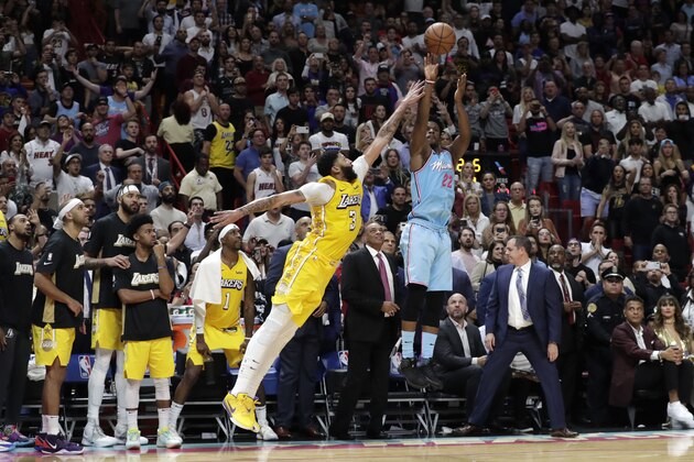 Miami Heat forward Jimmy Butler (22) attempts a three-point basket at the buzzer as Los Angeles Lakers forward Anthony Davis (3) defends during the second half of an NBA basketball game, Friday, Dec. 13, 2019, in Miami. (AP Photo/Lynne Sladky)