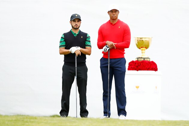 MELBOURNE, AUSTRALIA - DECEMBER 15:  Abraham Ancer of Mexico and the International team and Playing Captain Tiger Woods of the United States team stand on the first tee during Sunday Singles matches on day four of the 2019 Presidents Cup at Royal Melbourne Golf Course on December 15, 2019 in Melbourne, Australia. (Photo by Daniel Pockett/Getty Images)