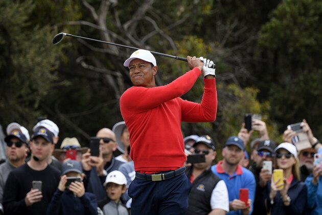 U.S. team player and captain Tiger Woods tees off at the 6th hole in his singles match during the President's Cup golf tournament at Royal Melbourne Golf Club in Melbourne, Sunday, Dec. 15, 2019. (AP Photo/Andy Brownbill)