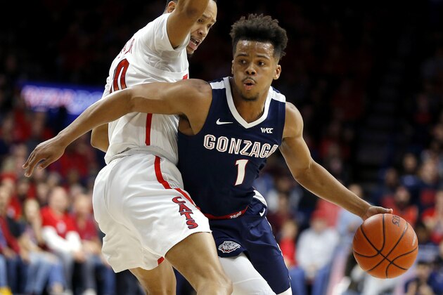 Gonzaga guard Admon Gilder (1) drives around Arizona guard Jemarl Baker Jr. in the first half of an NCAA college basketball game, Saturday, Dec. 14, 2019, in Tucson, Ariz. (AP Photo/Rick Scuteri)