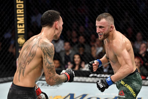 LAS VEGAS, NEVADA - DECEMBER 14:  (L-R) Alexander Volkanovski of Australia eyes Max Holloway in their UFC featherweight championship bout during the UFC 245 event at T-Mobile Arena on December 14, 2019 in Las Vegas, Nevada. (Photo by Jeff Bottari/Zuffa LLC)