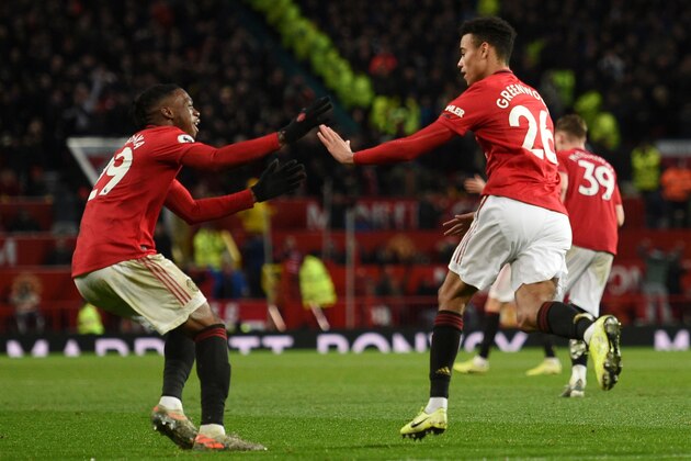 Manchester United's English striker Mason Greenwood (R) celebrates scoring their first goal to equalise 1-1 during the English Premier League football match between Manchester United and Everton at Old Trafford in Manchester, north west England, on December 15, 2019. (Photo by Oli SCARFF / AFP) / RESTRICTED TO EDITORIAL USE. No use with unauthorized audio, video, data, fixture lists, club/league logos or 'live' services. Online in-match use limited to 120 images. An additional 40 images may be used in extra time. No video emulation. Social media in-match use limited to 120 images. An additional 40 images may be used in extra time. No use in betting publications, games or single club/league/player publications. /  (Photo by OLI SCARFF/AFP via Getty Images)