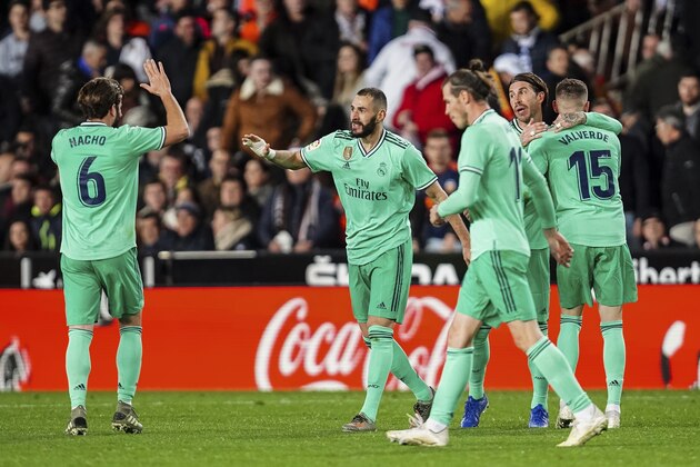 Real Madrid players celebrate the goal of their goalkeeper Thibaut Courtois during the Spanish La Liga soccer match between Valencia and Real Madrid at the Mestalla Stadium in Valencia, Spain, Sunday, December 15, 2019. (AP Photo/Alberto Saiz) Real Madrid players celebrate the goal of their goalkeeper Thibaut Courtois during the Spanish La Liga soccer match between Valencia and Real Madrid at the Mestalla Stadium in Valencia, Spain, Sunday, December 15, 2019. (AP Photo/Alberto Saiz)