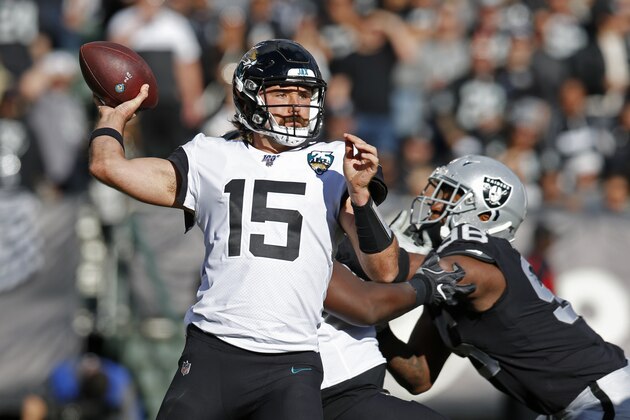 Jacksonville Jaguars quarterback Gardner Minshew throws the ball as Oakland Raiders defensive end Clelin Ferrell looks on during the second half of an NFL football game in Oakland, Calif., Sunday, Dec. 15, 2019. (AP Photo/D. Ross Cameron)