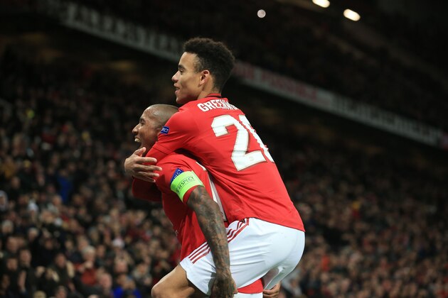 Manchester United's English defender Ashley Young (L) celebrates scoring the opening goal with Manchester United's English striker Mason Greenwood (R) during the UEFA Europa League group L football match between Manchester United and AZ Almaar at Old Trafford in Manchester, north west England, on December 12, 2019. (Photo by Lindsey Parnaby / AFP) (Photo by LINDSEY PARNABY/AFP via Getty Images)