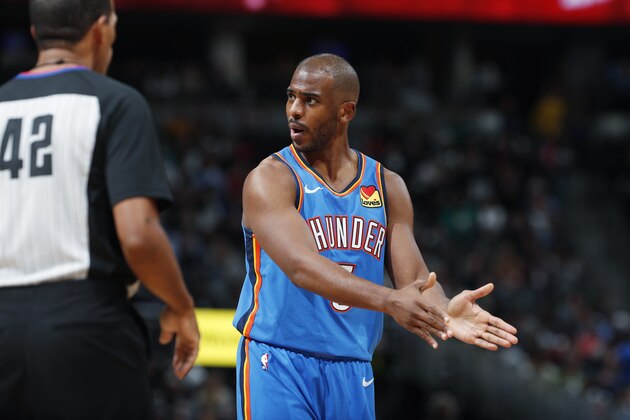 Oklahoma City Thunder guard Chris Paul, right, argues for a call with referee Eric Lewis in the second half of an NBA basketball game against the Denver Nuggets Saturday, Dec. 14, 2019, in Denver.  (AP Photo/David Zalubowski)