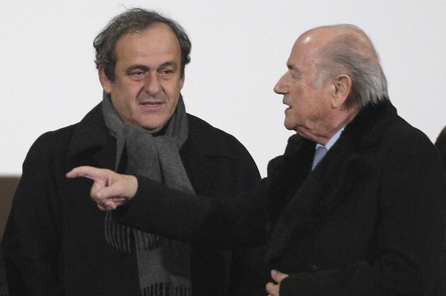 FILE - In this Dec. 16, 2014 file photo FIFA president Sepp Blatter, right, and UEFA president Michel Platini talk before the semi final soccer match between Real Madrid and Cruz Azul at the Club World Cup soccer tournament in Marrakech, Morocco. On Thursday, Oct. 8, 2015 file photo FIFA provisionally banned President Sepp Blatter and UEFA President Michel Platini for 90 days. (AP Photo/Christophe Ena, file)