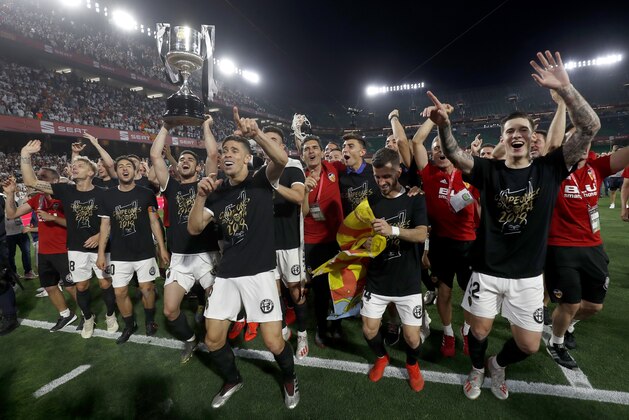 Valencia players celebrate with the trophy after winning the Copa del Rey soccer match final between Valencia CF and FC Barcelona at the Benito Villamarin stadium in Seville, Spain, Saturday. 25, 2019. (AP Photo/Miguel Morenatti) Valencia players celebrate with the trophy after winning the Copa del Rey soccer match final between Valencia CF and FC Barcelona at the Benito Villamarin stadium in Seville, Spain, Saturday. 25, 2019. (AP Photo/Miguel Morenatti)