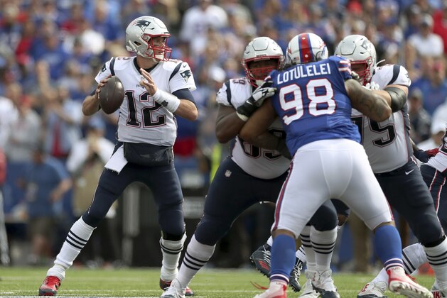 New England Patriots quarterback Tom Brady rolls out to pass under pressure from Buffalo Bills defensive tackle Star Lotulelei (98) in the second half of an NFL football game, Sunday, Sept. 29, 2019, in Orchard Park, N.Y. (AP Photo/Ron Schwane)