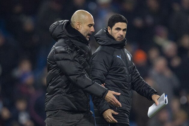 BURNLEY, ENGLAND - DECEMBER 03: Manchester City manager Pep Guardiola and his assistant coach Mikel Arteta walk across the pitch at half time during the Premier League match between Burnley FC and Manchester City at Turf Moor on December 3, 2019 in Burnley, United Kingdom. (Photo by Visionhaus)