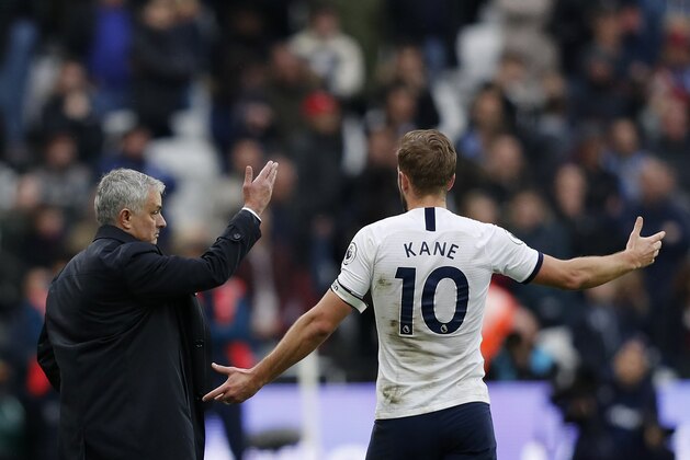 Tottenham Hotspur's Portuguese head coach Jose Mourinho (L) interacts with Tottenham Hotspur's English striker Harry Kane during the English Premier League football match between West Ham United and Tottenham Hotspur at The London Stadium, in east London on November 23, 2019. (Photo by Adrian DENNIS / AFP) / RESTRICTED TO EDITORIAL USE. No use with unauthorized audio, video, data, fixture lists, club/league logos or 'live' services. Online in-match use limited to 120 images. An additional 40 images may be used in extra time. No video emulation. Social media in-match use limited to 120 images. An additional 40 images may be used in extra time. No use in betting publications, games or single club/league/player publications. /  (Photo by ADRIAN DENNIS/AFP via Getty Images)