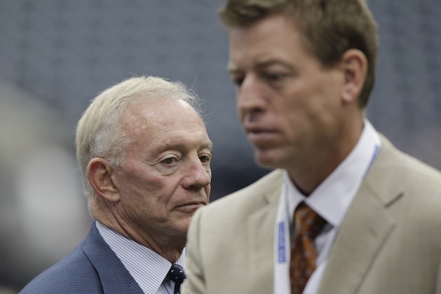 Dallas Cowboys owner Jerry Jones, left, looks on as former Cowboys quarterback Troy Aikman walks off the field before an NFL football game against the Houston Texans Sunday, Sept. 26, 2010, in Houston. (AP Photo/David J. Phillip)