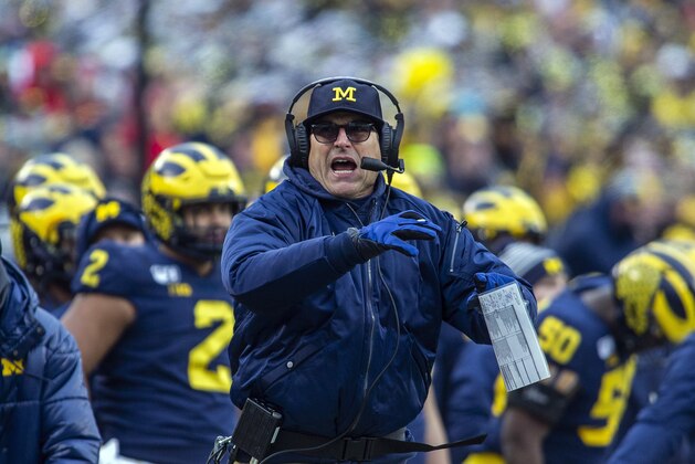 Michigan head coach Jim Harbaugh calls a timeout in the third quarter of an NCAA college football game against Ohio State in Ann Arbor, Mich., Saturday, Nov. 30, 2019. Ohio State won 56-27. (AP Photo/Tony Ding)